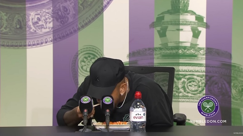 Nick Kyrgios prend son repas en conférence de presse à Wimbledon. Tranquille.